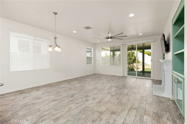 1536 Williamson, Beaumont, CA 92223 - unfurnished living room with light wood-style floors, recessed lighting, ceiling fan, a chandelier, and a fireplace