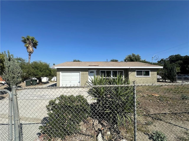 2480 Hall Ave, Jurupa Valley, CA 92509 - view of front facade with concrete driveway, stucco siding, and a garage