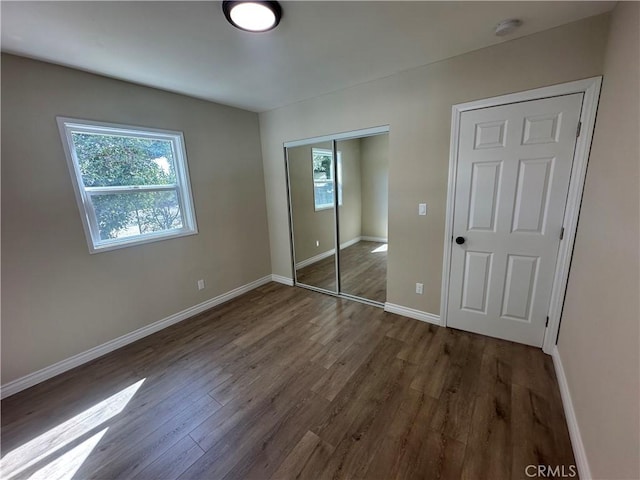 2480 Hall Ave, Jurupa Valley, CA 92509 - unfurnished bedroom with wood finished floors, a closet, and baseboards