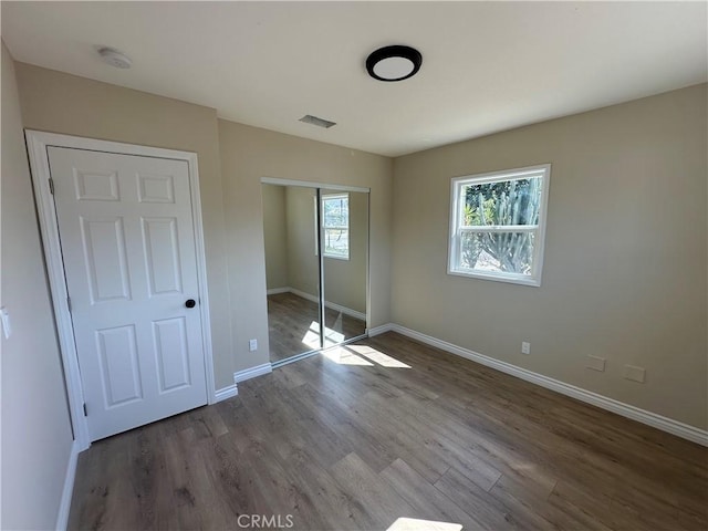 2480 Hall Ave, Jurupa Valley, CA 92509 - unfurnished bedroom featuring a closet, wood finished floors, and baseboards