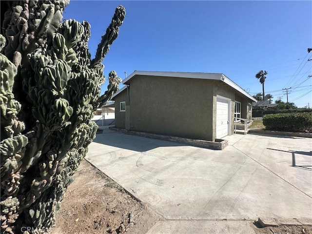 2480 Hall Ave, Jurupa Valley, CA 92509 - back of house with stucco siding and driveway