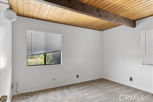 28921 Bear Valley Rd, Tehachapi, CA 93561 - carpeted empty room with wood ceiling with exposed beams