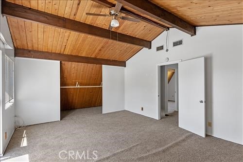 28921 Bear Valley Rd, Tehachapi, CA 93561 - empty room with wooden ceiling, carpet flooring, and a ceiling fan