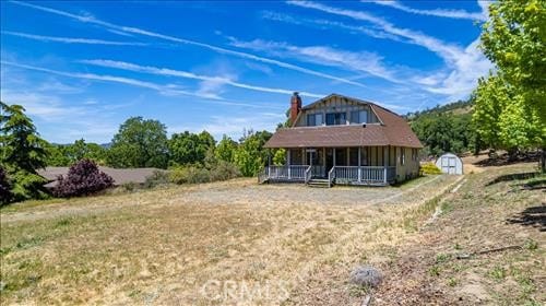 28921 Bear Valley Rd, Tehachapi, CA 93561 - back of house featuring a porch and a chimney