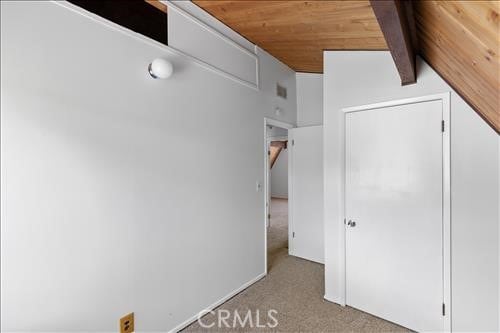 28921 Bear Valley Rd, Tehachapi, CA 93561 - unfurnished bedroom featuring wooden ceiling, carpet, and vaulted ceiling