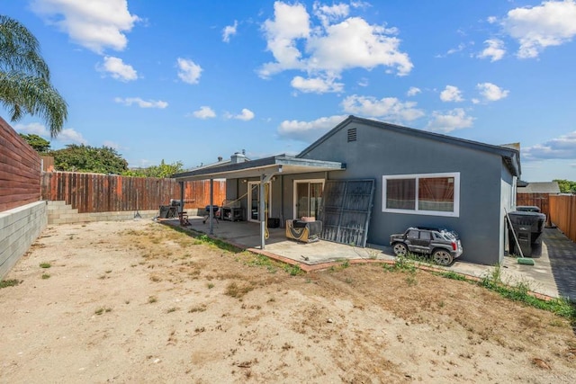 146 Padre Tullio Dr, San Ysidro, CA 92173 - rear view of property featuring a patio, a fenced backyard, and stucco siding