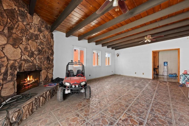 146 Padre Tullio Dr, San Ysidro, CA 92173 - living room featuring a ceiling fan, wood ceiling with exposed beams, a stone fireplace, and stone finish flooring