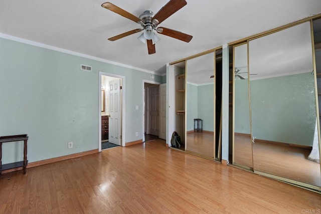 146 Padre Tullio Dr, San Ysidro, CA 92173 - unfurnished bedroom featuring two closets, ornamental molding, wood finished floors, baseboards, and connected bathroom