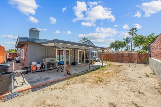 146 Padre Tullio Dr, San Ysidro, CA 92173 - rear view of property featuring a patio, a chimney, a fenced backyard, and stucco siding