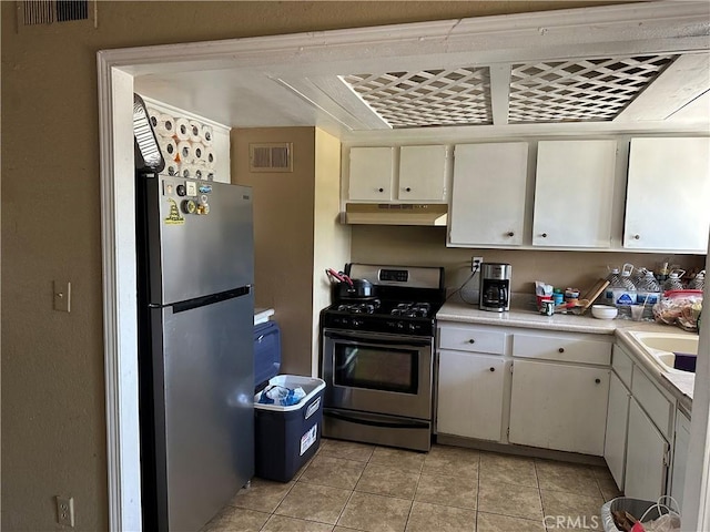 211 N Fillmore Ave, Rialto, CA 92376 - kitchen with stainless steel appliances, under cabinet range hood, light countertops, light tile patterned floors, and a sink