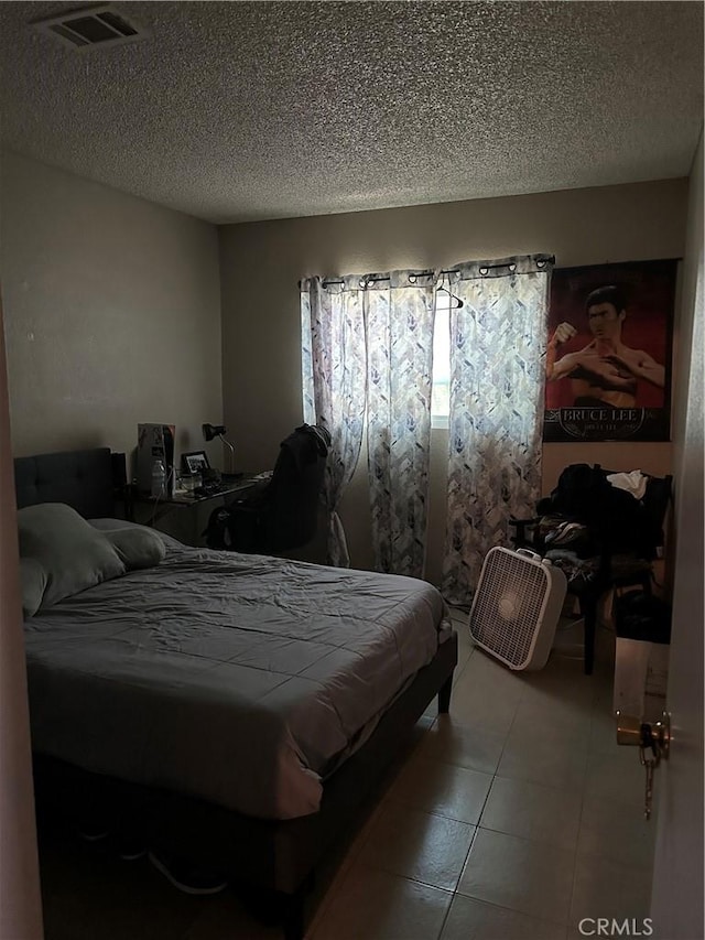 211 N Fillmore Ave, Rialto, CA 92376 - tiled bedroom featuring a textured ceiling