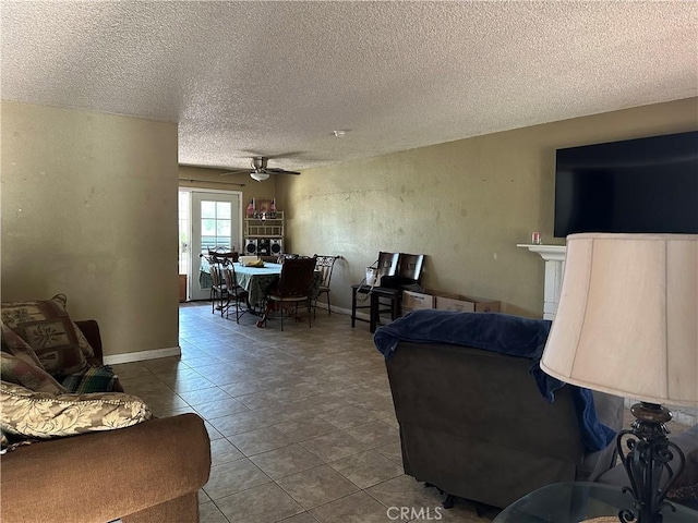 211 N Fillmore Ave, Rialto, CA 92376 - tiled living area featuring a ceiling fan, a textured ceiling, and baseboards