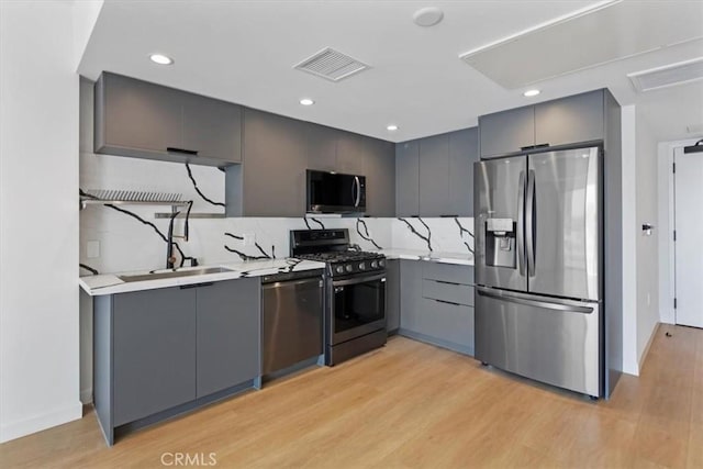 321 S Oxford Ave Unit 606, Los Angeles, CA 90020 - kitchen featuring appliances with stainless steel finishes, gray cabinetry, light wood-style flooring, light countertops, and recessed lighting