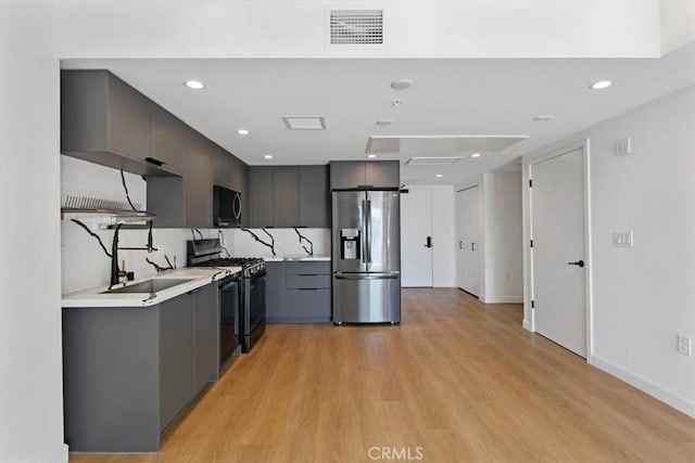 321 S Oxford Ave Unit 606, Los Angeles, CA 90020 - kitchen featuring stainless steel appliances, gray cabinets, modern cabinets, light countertops, and light wood-style flooring