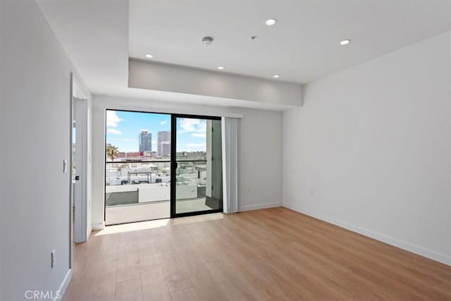 321 S Oxford Ave Unit 606, Los Angeles, CA 90020 - unfurnished room featuring recessed lighting, light wood-style flooring, baseboards, a city view, and a smoke detector