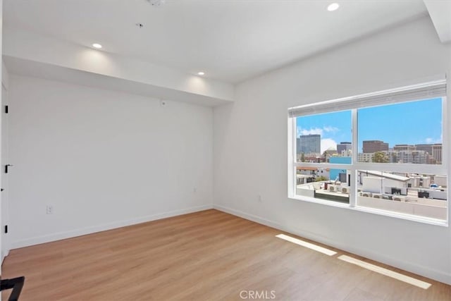 321 S Oxford Ave Unit 606, Los Angeles, CA 90020 - empty room featuring wood finished floors, recessed lighting, baseboards, and a view of city