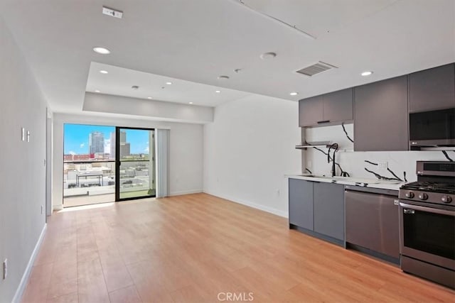 321 S Oxford Ave Unit 606, Los Angeles, CA 90020 - kitchen featuring appliances with stainless steel finishes, gray cabinets, baseboards, light wood-style floors, and recessed lighting