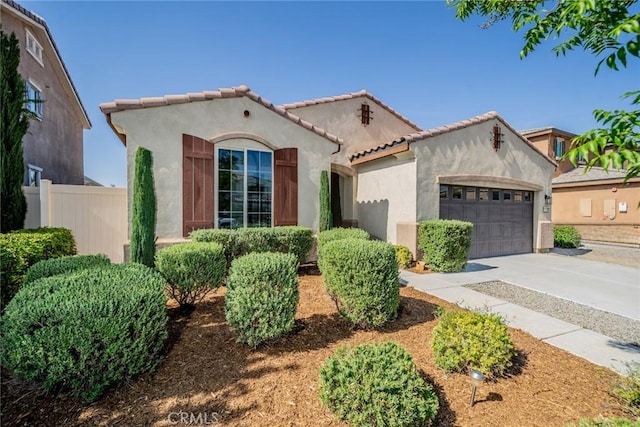 1060 Fortuna St, Perris, CA 92571 - mediterranean / spanish house with a garage, stucco siding, driveway, and a tile roof