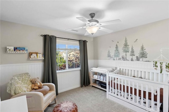 45614 Hawk Ct, Temecula, CA 92592 - carpeted bedroom with a nursery area, a wainscoted wall, and ceiling fan
