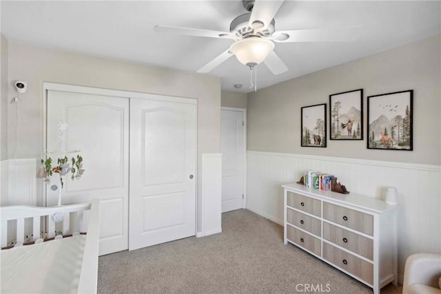 45614 Hawk Ct, Temecula, CA 92592 - carpeted bedroom with wainscoting, a closet, and a ceiling fan