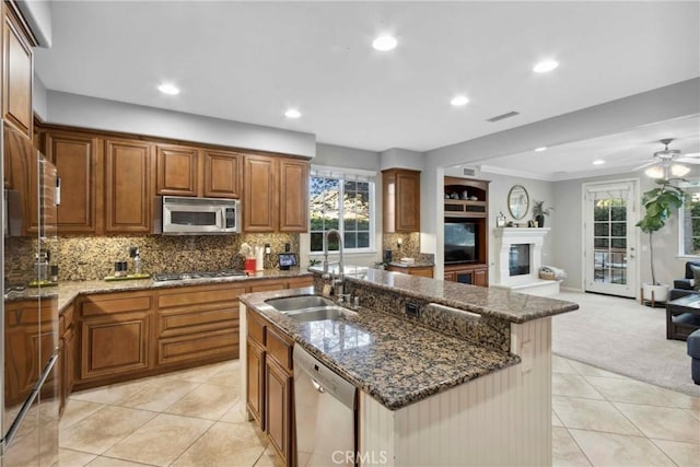 45614 Hawk Ct, Temecula, CA 92592 - kitchen featuring a sink, stainless steel appliances, open floor plan, light carpet, and recessed lighting