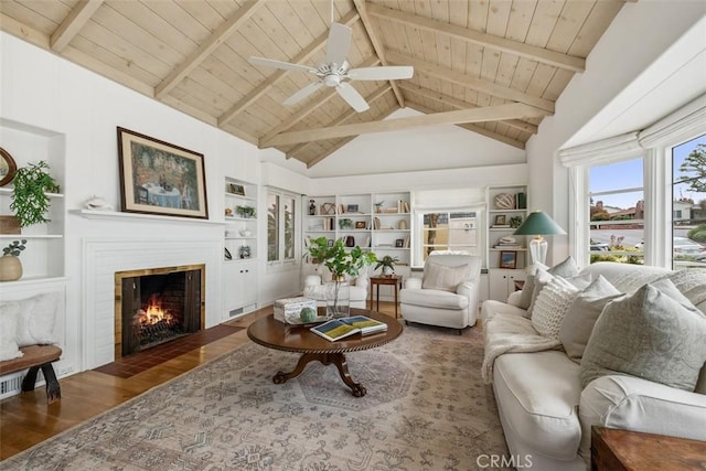 27 S La Senda Dr, Laguna Beach, CA 92651 - living room with wood finished floors, wood ceiling, built in shelves, a ceiling fan, and a fireplace with flush hearth