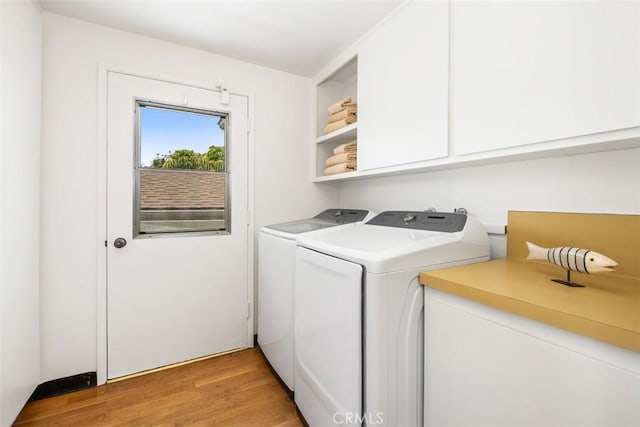 27 S La Senda Dr, Laguna Beach, CA 92651 - laundry room featuring cabinet space, independent washer and dryer, and light wood-style floors