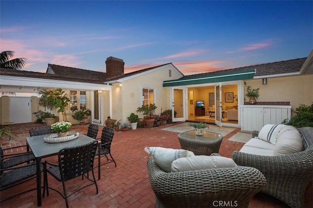 27 S La Senda Dr, Laguna Beach, CA 92651 - back of property featuring a patio, a chimney, stucco siding, and outdoor dining area