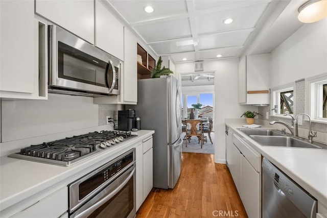 27 S La Senda Dr, Laguna Beach, CA 92651 - kitchen featuring appliances with stainless steel finishes, a sink, recessed lighting, coffered ceiling, and white cabinets