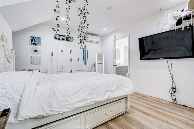 320 E Walnut Ave, El Segundo, CA 90245 - bedroom with a wall unit AC, light wood-style floors, ensuite bath, baseboards, and vaulted ceiling