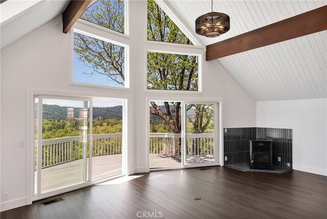 28720 Zion Dr, Lake Arrowhead, CA 92352 - unfurnished living room featuring high vaulted ceiling, beam ceiling, wood finished floors, a wood stove, and baseboards