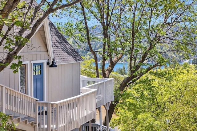 28720 Zion Dr, Lake Arrowhead, CA 92352 - view of side of property featuring a shingled roof and a deck with water view