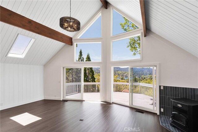 28720 Zion Dr, Lake Arrowhead, CA 92352 - unfurnished living room with wood finished floors, beamed ceiling, a skylight, high vaulted ceiling, and baseboards