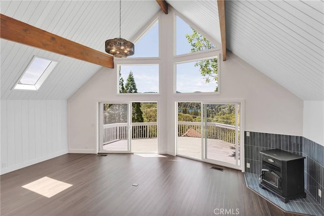 28720 Zion Dr, Lake Arrowhead, CA 92352 - unfurnished living room featuring a wood stove, wood finished floors, a skylight, and baseboards