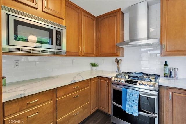 28720 Zion Dr, Lake Arrowhead, CA 92352 - kitchen featuring appliances with stainless steel finishes, wall chimney exhaust hood, light stone countertops, and tasteful backsplash