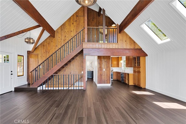 28720 Zion Dr, Lake Arrowhead, CA 92352 - unfurnished living room featuring a skylight, stairway, high vaulted ceiling, plenty of natural light, and wooden walls