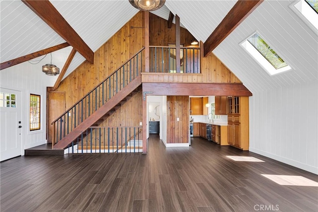 28720 Zion Dr, Lake Arrowhead, CA 92352 - unfurnished living room with a skylight, stairs, healthy amount of natural light, high vaulted ceiling, and wood walls