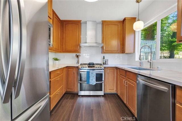 28720 Zion Dr, Lake Arrowhead, CA 92352 - kitchen featuring appliances with stainless steel finishes, wall chimney exhaust hood, light stone counters, and dark wood-style flooring