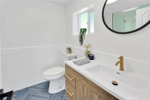 28720 Zion Dr, Lake Arrowhead, CA 92352 - bathroom with wainscoting, toilet, vanity, and tile patterned floors