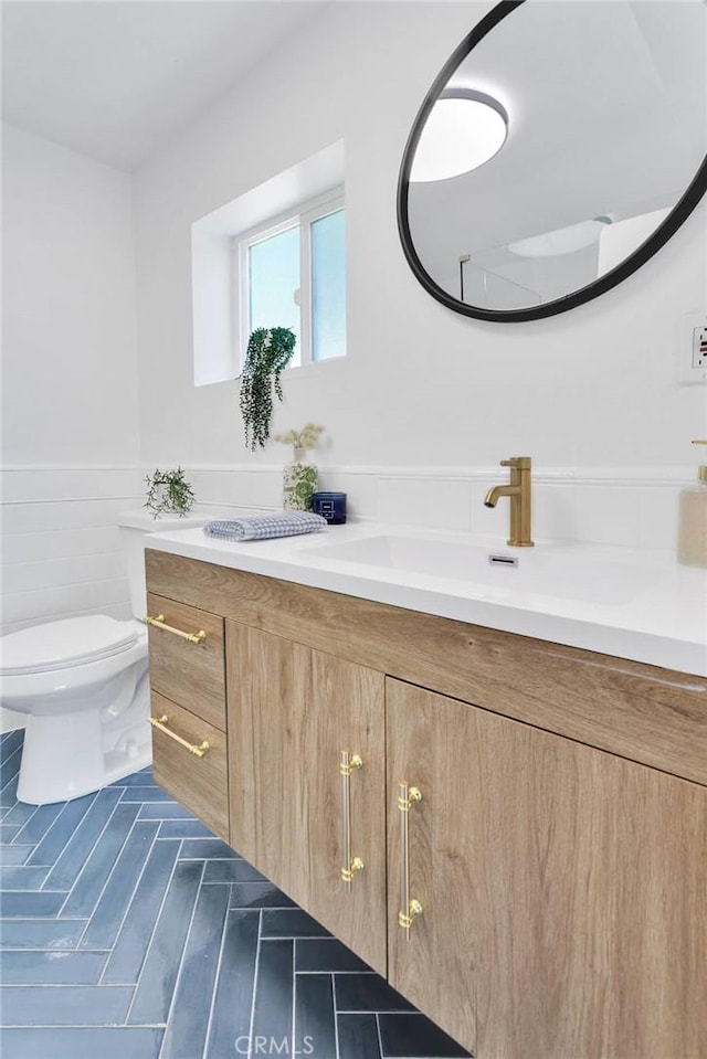 28720 Zion Dr, Lake Arrowhead, CA 92352 - bathroom featuring vanity, a wainscoted wall, and toilet