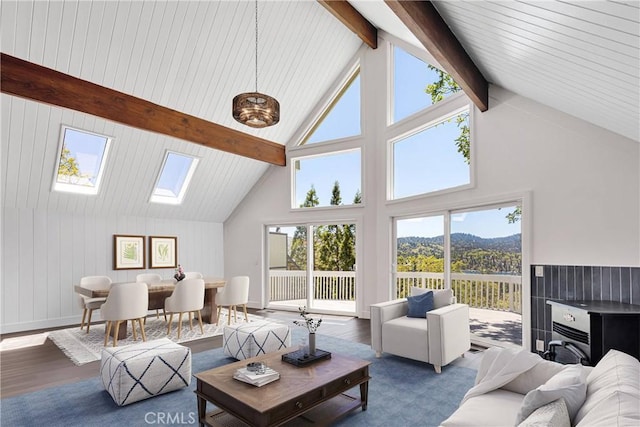 28720 Zion Dr, Lake Arrowhead, CA 92352 - living room featuring wood finished floors, beam ceiling, high vaulted ceiling, a skylight, and plenty of natural light