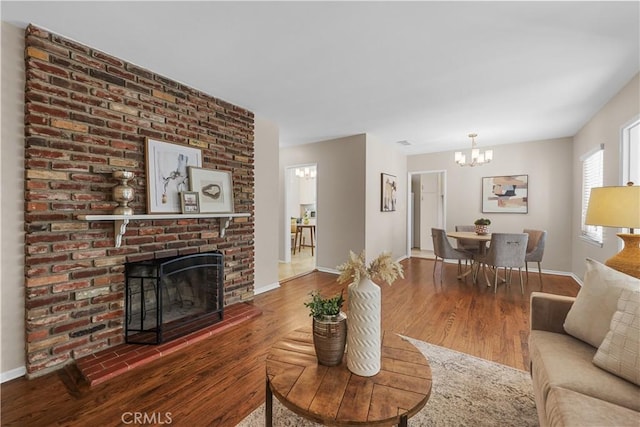 1840 W Southgate Ave, Fullerton, CA 92833 - living area featuring a chandelier, wood finished floors, baseboards, and a fireplace