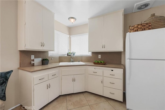 1840 W Southgate Ave, Fullerton, CA 92833 - kitchen with freestanding refrigerator, a sink, tasteful backsplash, light countertops, and white cabinets