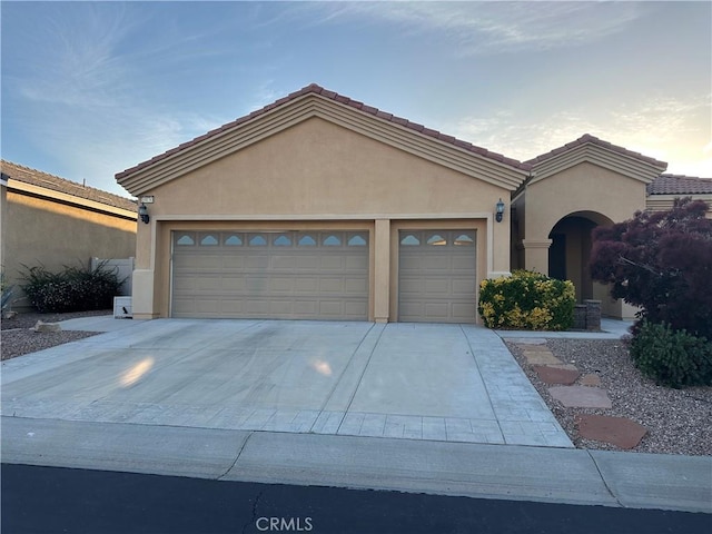 10030 El Dorado St, Apple Valley, CA 92308 - view of front of home featuring stucco siding, a garage, and driveway
