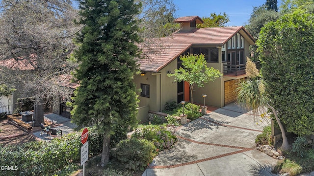 684 Orange Dr, Sierra Madre, CA 91024 - view of front of home featuring a tile roof, driveway, and a patio