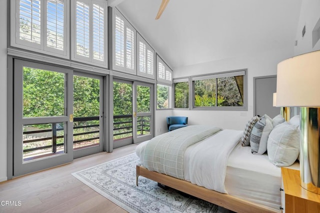 684 Orange Dr, Sierra Madre, CA 91024 - bedroom with high vaulted ceiling, access to exterior, and wood finished floors