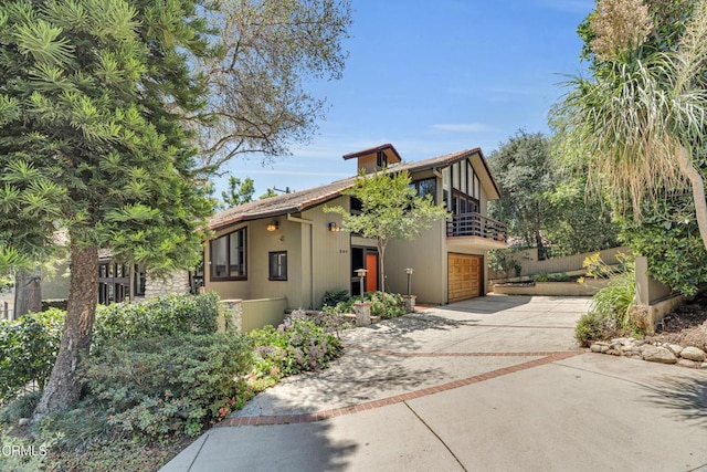 684 Orange Dr, Sierra Madre, CA 91024 - view of front of home featuring driveway, a balcony, and an attached garage