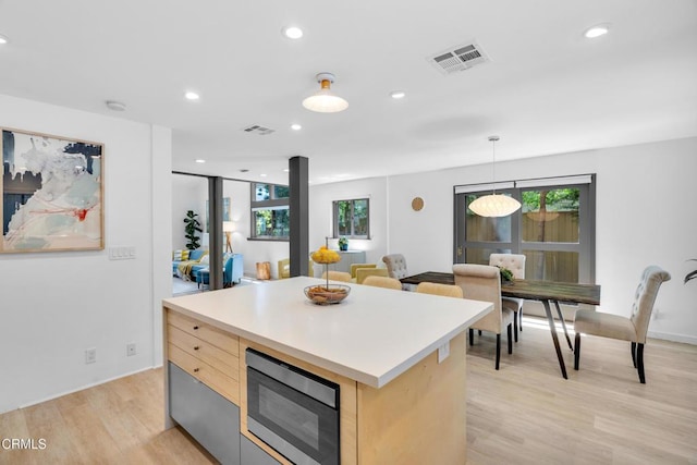684 Orange Dr, Sierra Madre, CA 91024 - kitchen featuring built in microwave, recessed lighting, light wood-type flooring, light brown cabinetry, and light countertops