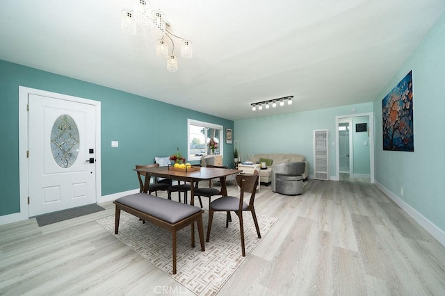 1405 W Saint Gertrude Pl, Santa Ana, CA 92704 - dining room with light wood-style floors, baseboards, and a chandelier