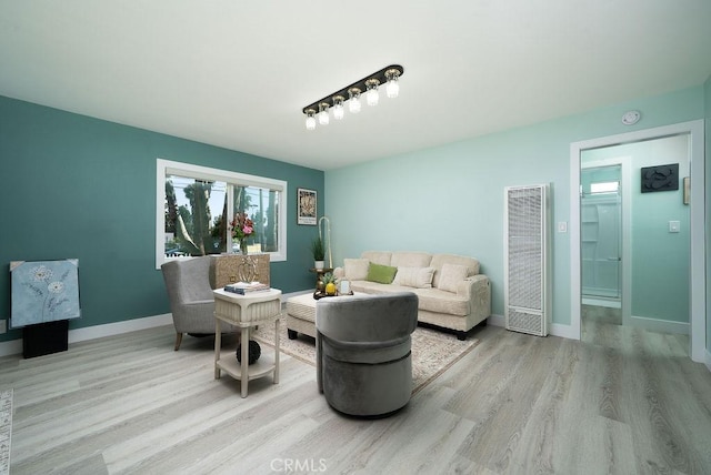1405 W Saint Gertrude Pl, Santa Ana, CA 92704 - living area featuring a heating unit, wood finished floors, and baseboards